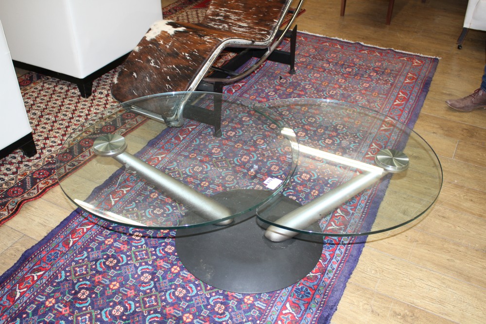 A stylish glass occasional table, with swivelling two section top, Diam. when closed 80cm, H.42cm